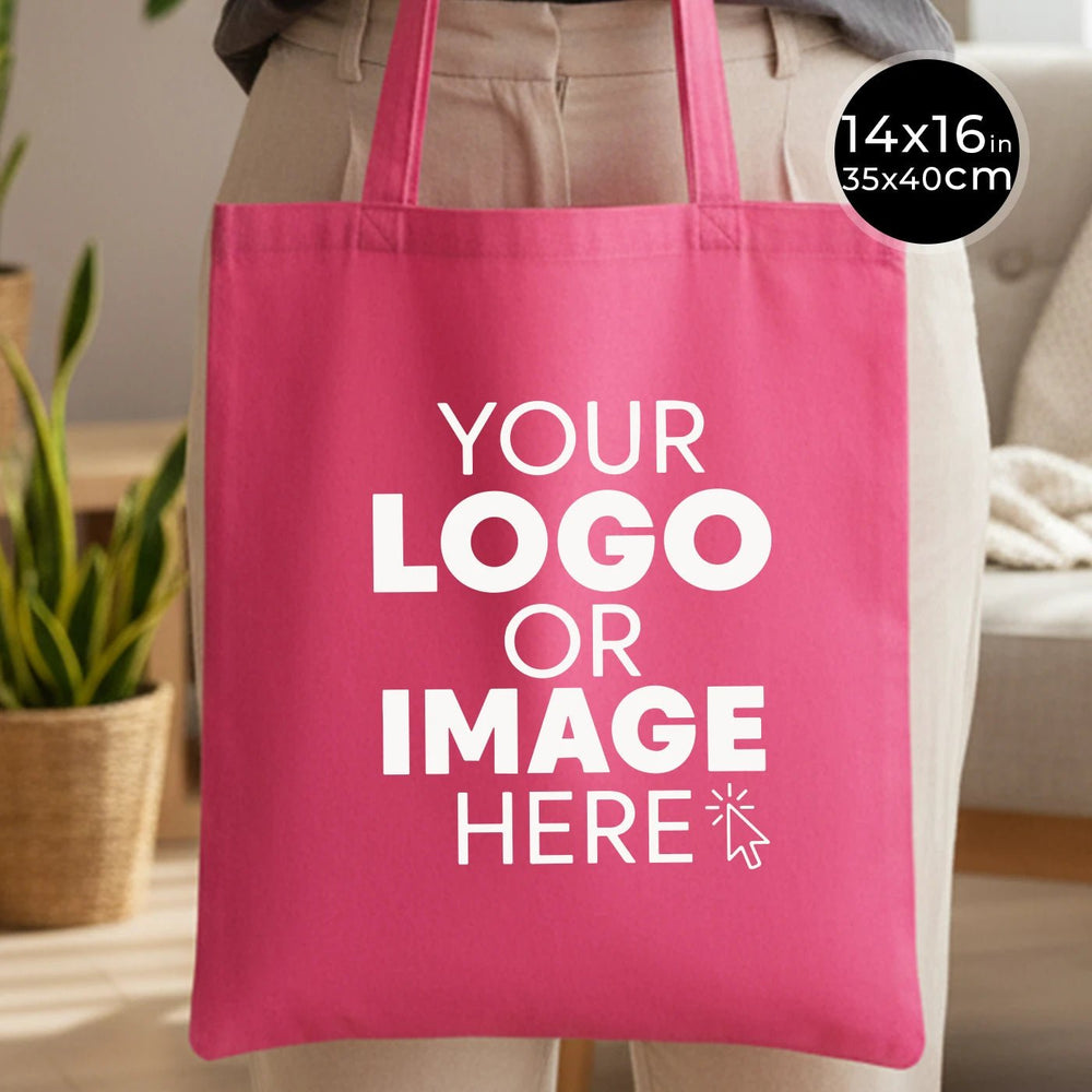 Pink tote bag with 'Your Logo or Image Here' text, held by a person in a casual setting.