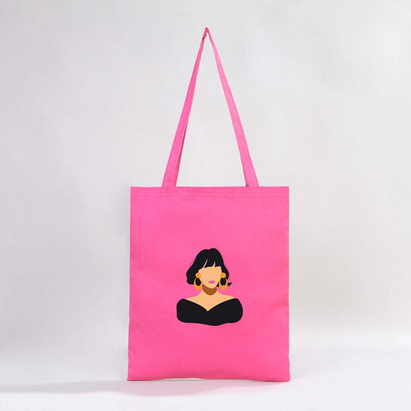 Pink tote bag with a graphic of a woman's face on a white background