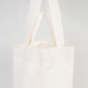 White tote bag on a light gray background