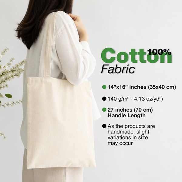 Person holding a beige tote bag with product details on a light gray background