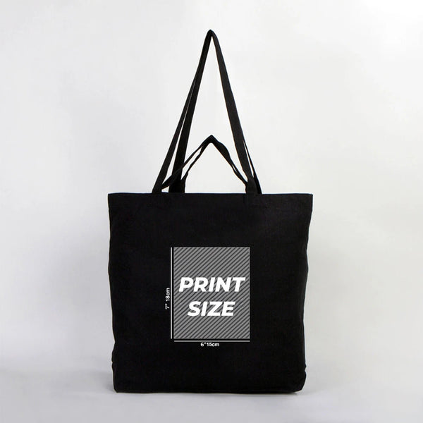 Black tote bag with print size information on a white background