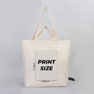 Beige tote bag with printed dimensions on a gray background