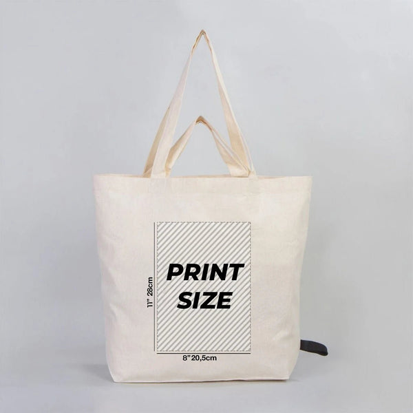 Beige tote bag with printed dimensions on a gray background