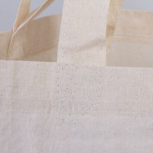 Close-up of a beige tote bag with visible stitching details.